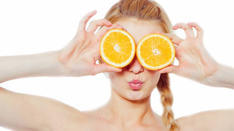 Woman and oranges - benefit and harm