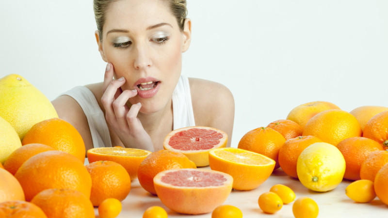 Woman and oranges - benefit and harm