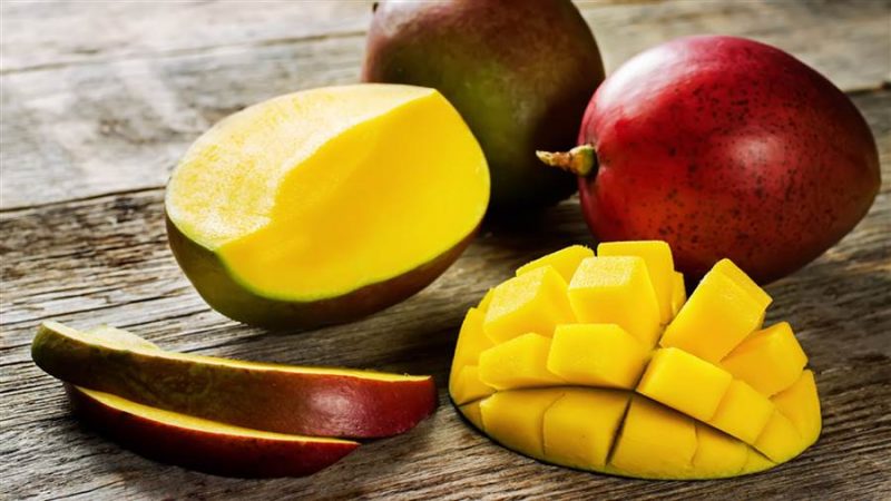What is the calorie content of mango and what are its benefits and harms